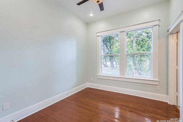 empty room with hardwood / wood-style floors and ceiling fan