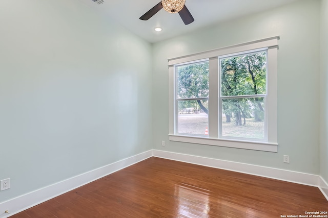 spare room with wood-type flooring and ceiling fan