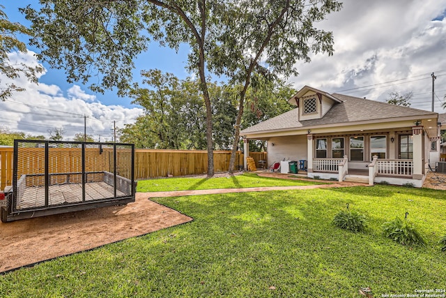 view of yard featuring central AC and a porch