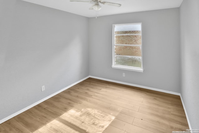 spare room featuring light hardwood / wood-style flooring and ceiling fan