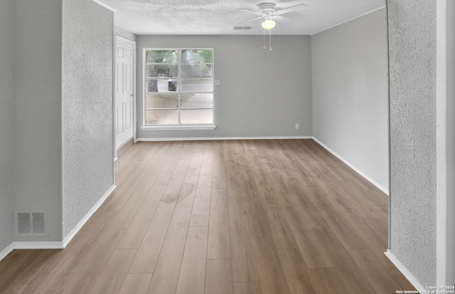 spare room with ceiling fan and wood-type flooring