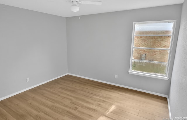 unfurnished room with ceiling fan and light wood-type flooring