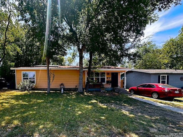 single story home with a front lawn and covered porch