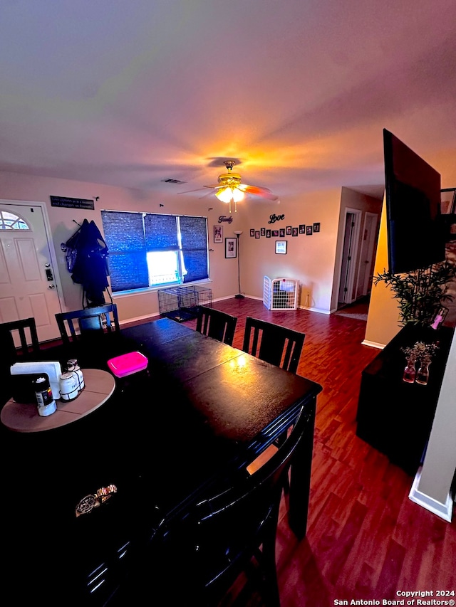 dining space featuring ceiling fan and dark hardwood / wood-style flooring