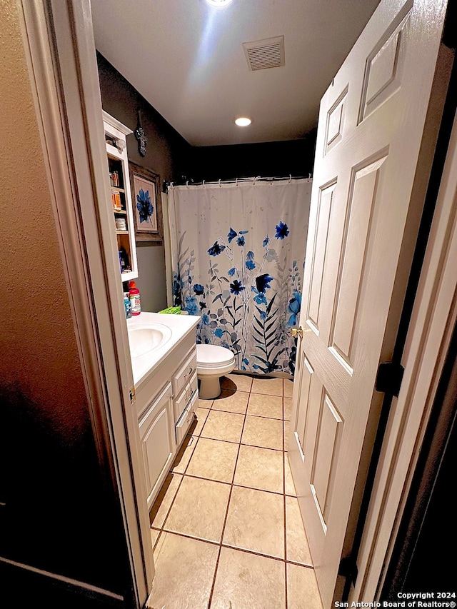 bathroom featuring vanity, tile patterned flooring, toilet, and a shower with curtain