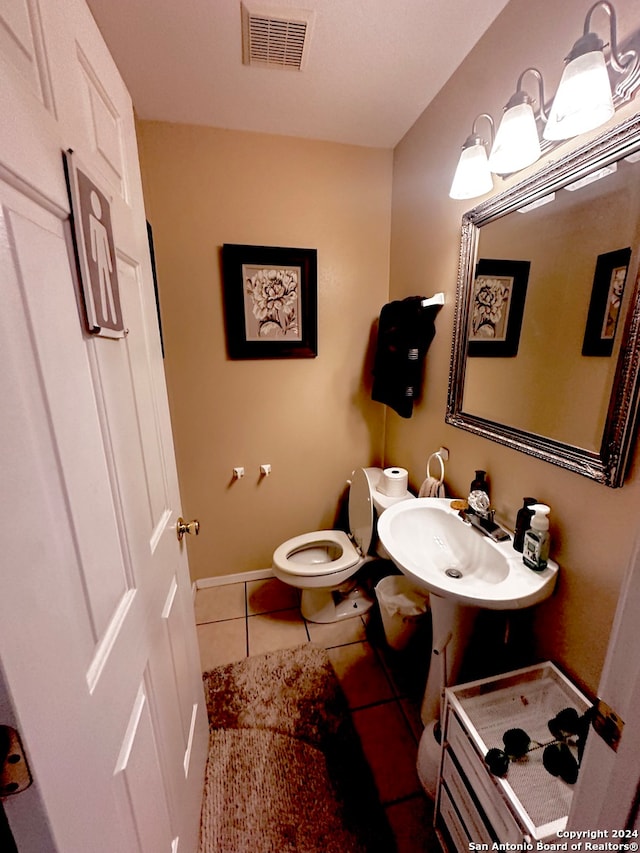 bathroom with tile patterned flooring, sink, and toilet