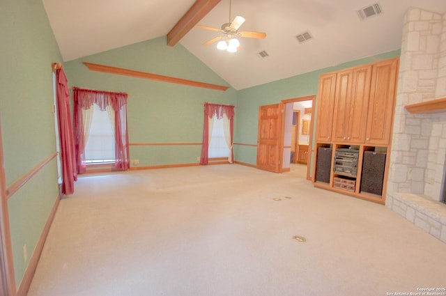 unfurnished living room featuring ceiling fan, vaulted ceiling with beams, and light carpet