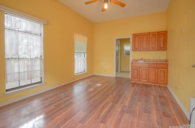 interior space featuring ceiling fan, dark hardwood / wood-style flooring, a wealth of natural light, and sink