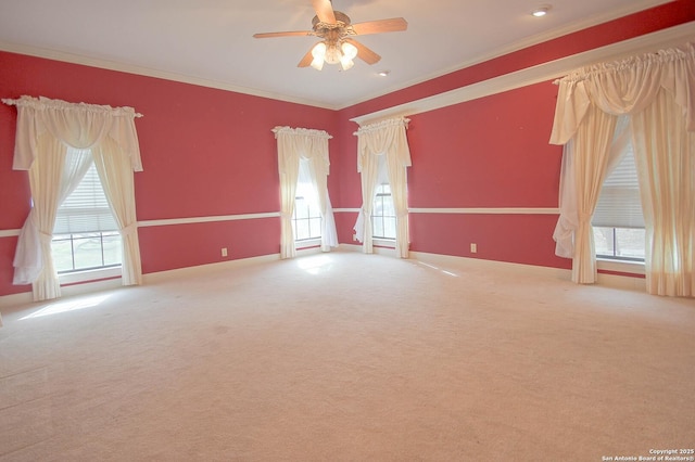 spare room featuring plenty of natural light, crown molding, and carpet floors