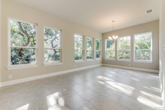 unfurnished sunroom with an inviting chandelier