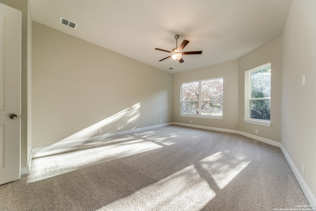 unfurnished room with ceiling fan and carpet flooring