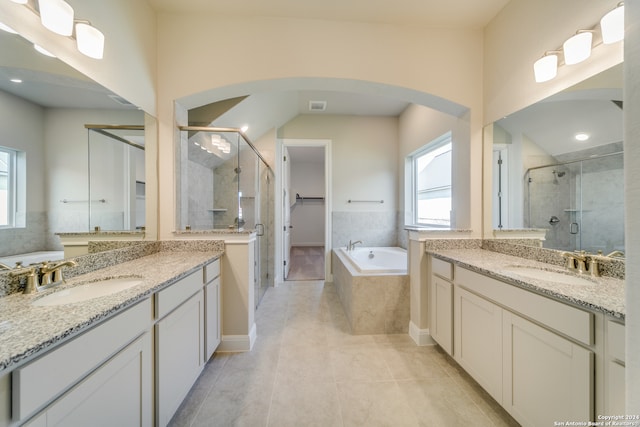 bathroom featuring independent shower and bath, vanity, and tile patterned floors