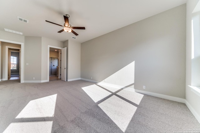 unfurnished bedroom with light colored carpet, baseboards, and visible vents
