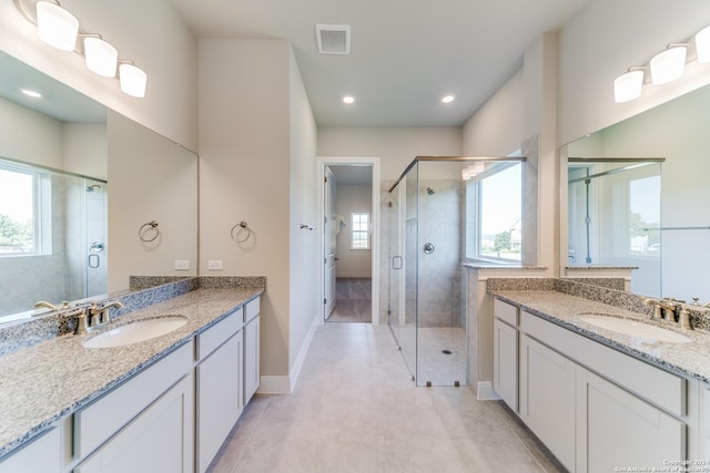 full bath with visible vents, baseboards, a sink, and a stall shower