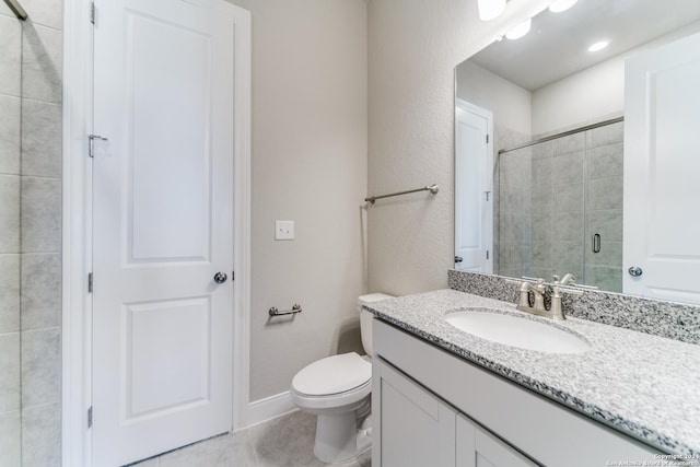 full bathroom featuring tile patterned flooring, toilet, a stall shower, and vanity