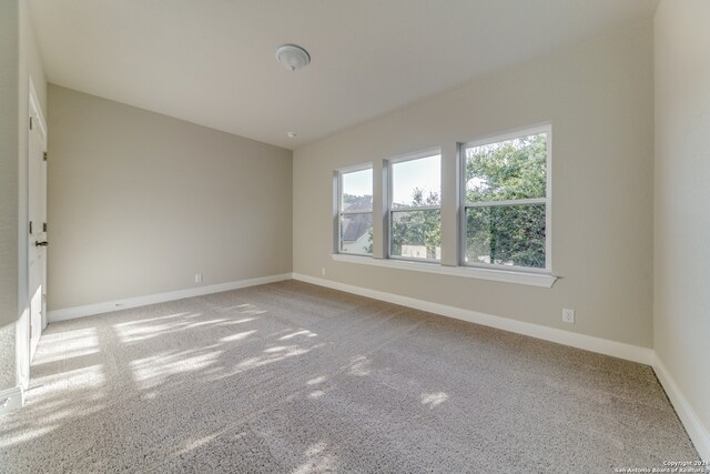 spare room with light colored carpet