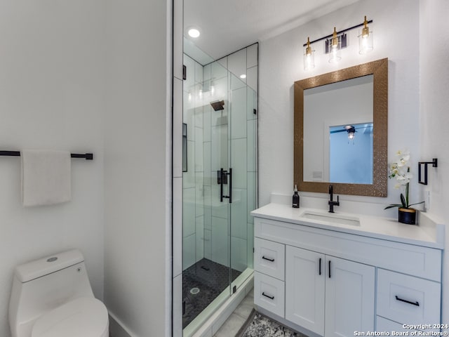 bathroom featuring walk in shower, ceiling fan, vanity, and toilet