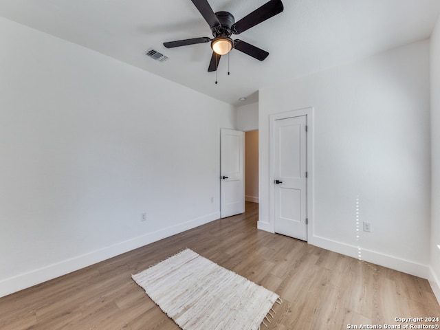 spare room featuring ceiling fan and light hardwood / wood-style floors