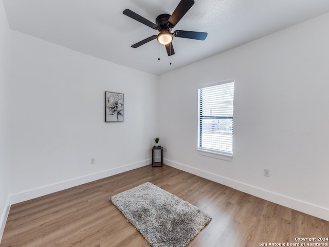 spare room featuring wood-type flooring and ceiling fan