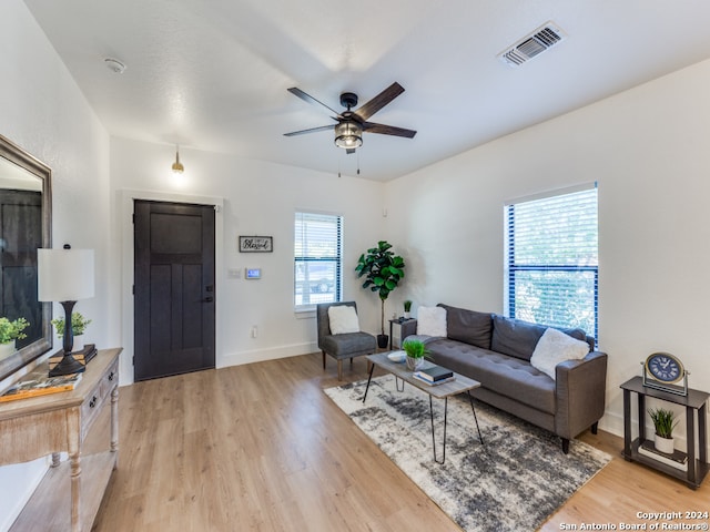 living room featuring ceiling fan and light wood-type flooring