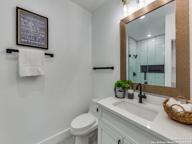 bathroom with vanity, walk in shower, and toilet