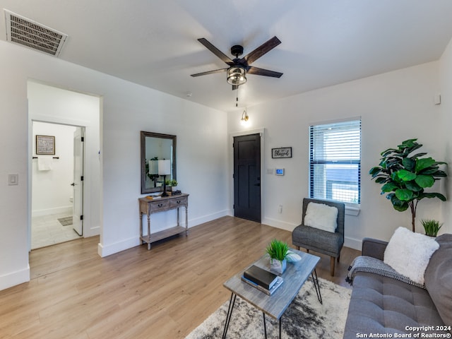 living room with ceiling fan and light hardwood / wood-style floors