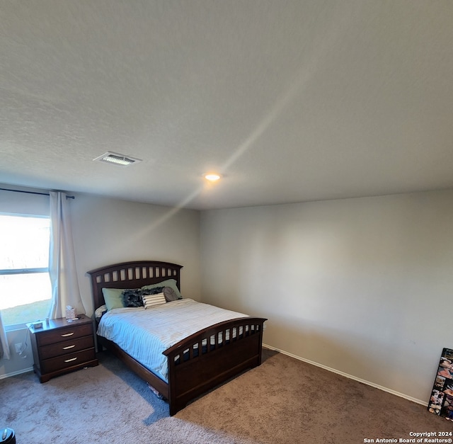 carpeted bedroom with a textured ceiling