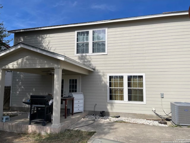 back of property with ceiling fan, a patio area, and central air condition unit