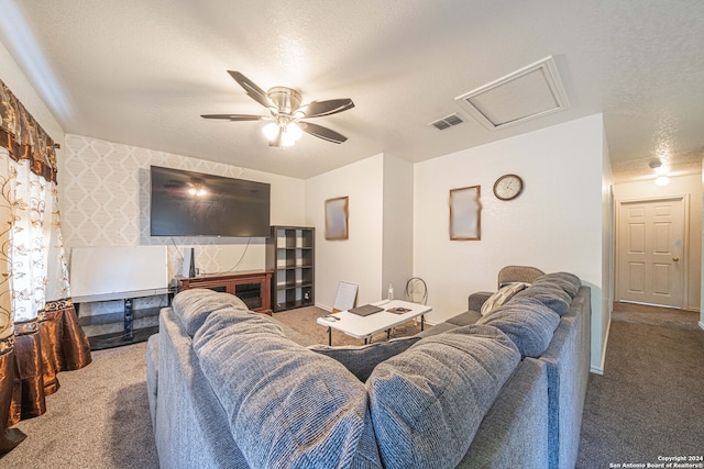 carpeted living room featuring a textured ceiling and ceiling fan