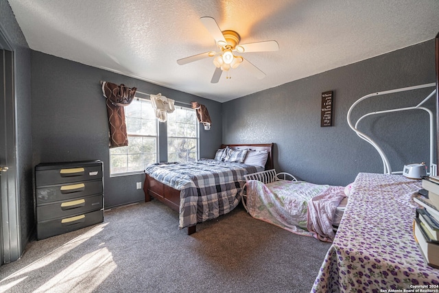 carpeted bedroom featuring ceiling fan and a textured ceiling