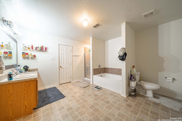 full bathroom with vanity, toilet, a textured ceiling, and independent shower and bath