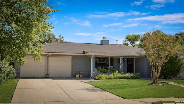 single story home featuring a garage, a front lawn, and covered porch