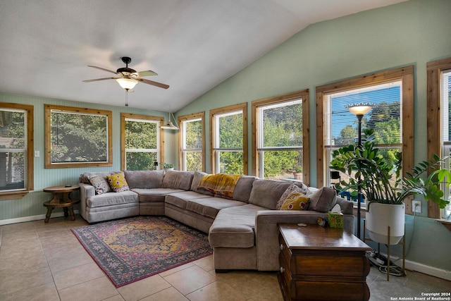 living room featuring ceiling fan, light tile patterned flooring, and vaulted ceiling