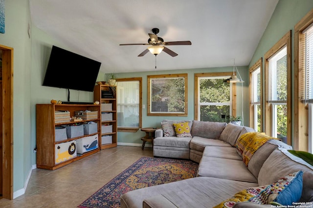 tiled living room with ceiling fan and vaulted ceiling