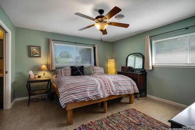 bedroom featuring light tile patterned floors and ceiling fan