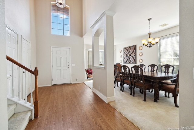 entryway featuring a notable chandelier and wood-type flooring