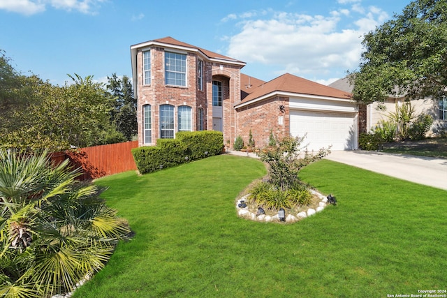 view of front of house with a front yard and a garage