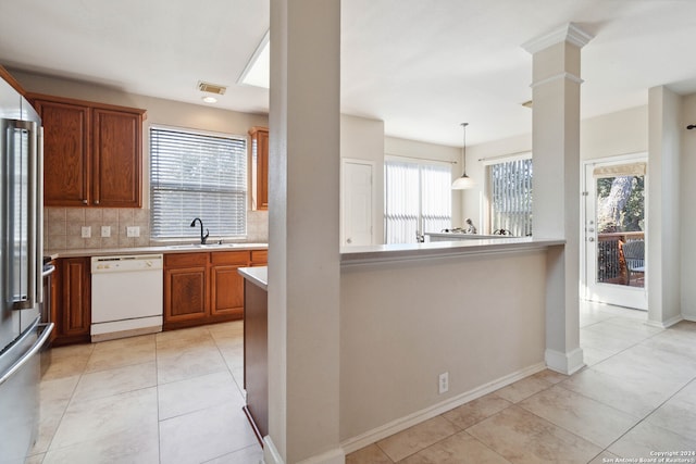 kitchen with dishwasher, tasteful backsplash, pendant lighting, and a wealth of natural light