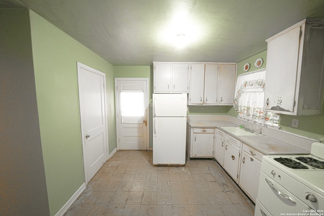 kitchen featuring white appliances, sink, and white cabinets