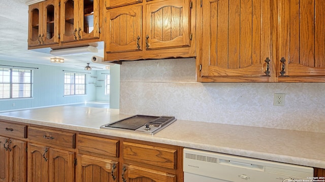 kitchen with dishwasher, backsplash, stainless steel gas cooktop, and ceiling fan