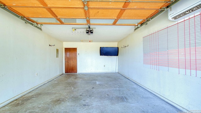 garage with a garage door opener and a wall mounted air conditioner