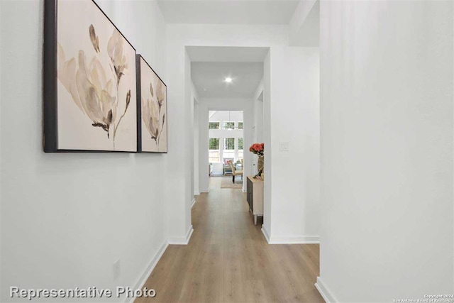 hallway with light hardwood / wood-style flooring