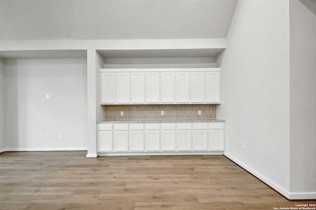 interior space featuring hardwood / wood-style flooring and backsplash