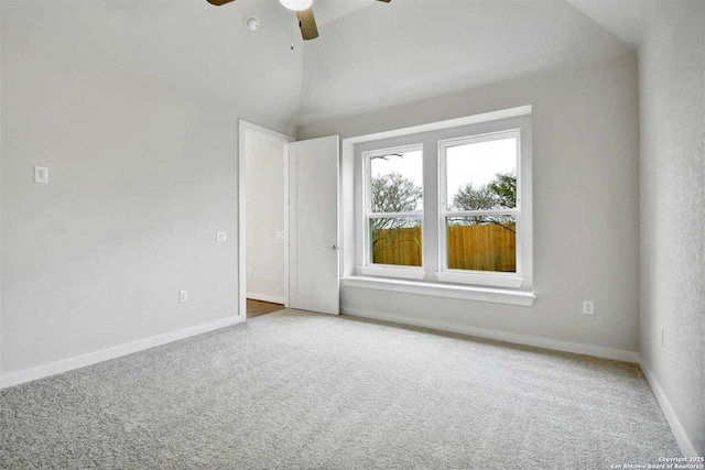 carpeted spare room with vaulted ceiling and ceiling fan