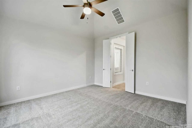 carpeted empty room with lofted ceiling and ceiling fan