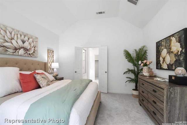 bedroom featuring lofted ceiling and light colored carpet