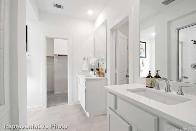 bathroom featuring vanity, tile patterned flooring, and a shower with door