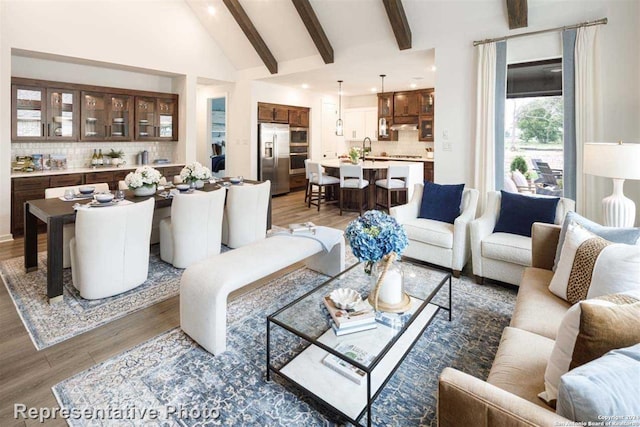 living room featuring high vaulted ceiling, beam ceiling, dark hardwood / wood-style flooring, and sink