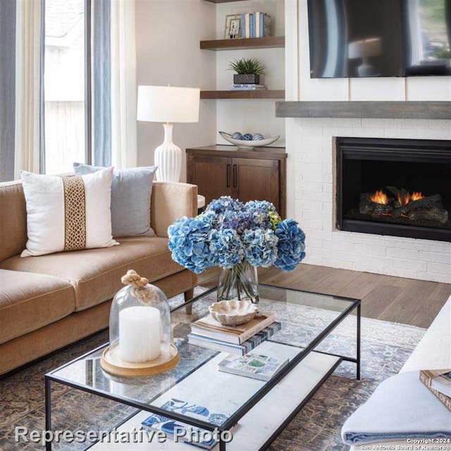 living room featuring hardwood / wood-style flooring and a fireplace