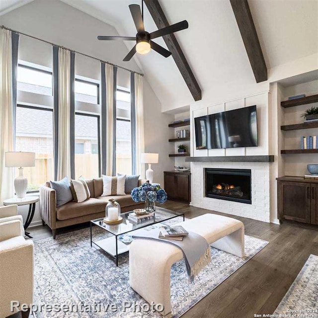 living room with ceiling fan, hardwood / wood-style flooring, plenty of natural light, and vaulted ceiling with beams